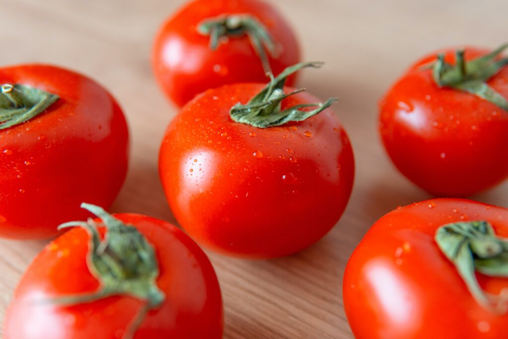 Ripe, succulent tomatoes showcased in a visually captivating, high-resolution image, bursting with vibrant colors and fresh appeal.